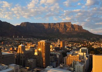 Cape Town, South Africa with table mountain in the background. it is a golden, sunny day.