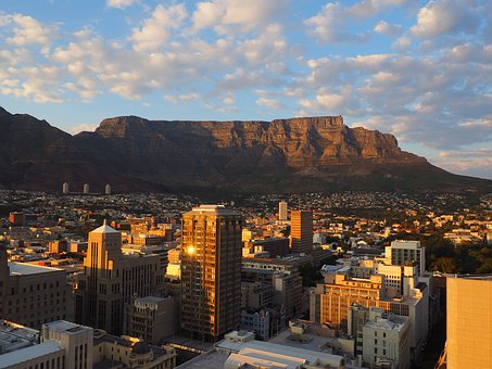 Cape Town, South Africa with table mountain in the background. it is a golden, sunny day.