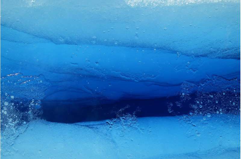 a close up of a crevasse underneath an ice sheet in Antarctica. It is vivid blue.