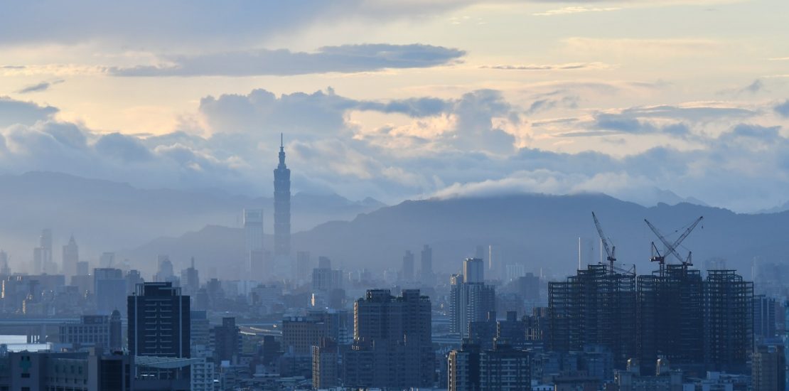 distant shot of Taipei, Taiwan. smokey skyscrapers can be seen in the cloudy dawn